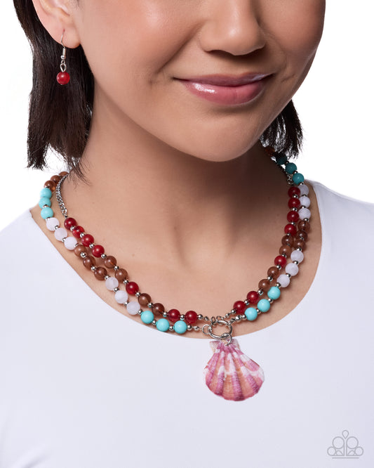 Close-up of a woman wearing a colorful beaded necklace with a shell pendant on a white background