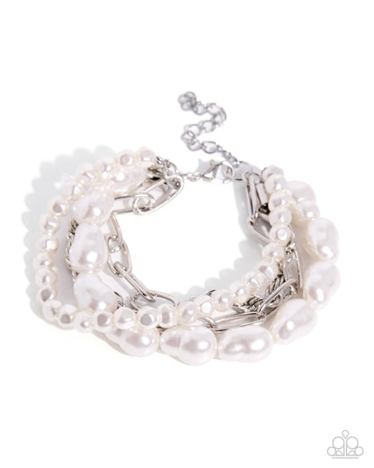 A multi-strand pearl and silver chain bracelet with a lobster clasp, shown on a white background with a Paparazzi logo watermark in the corner.