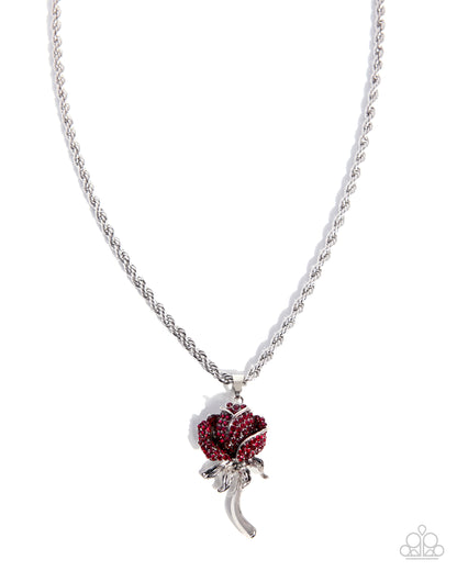 Silver necklace with a red rose pendant on a white background