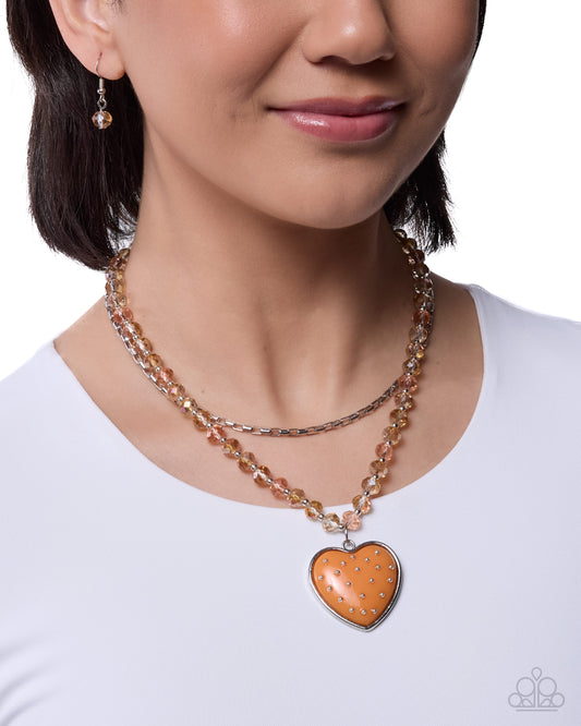 Woman wearing a necklace with a heart-shaped pendant on a white background