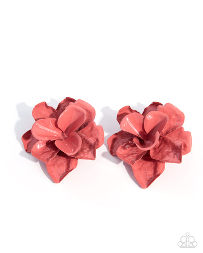 Pair of red flower-shaped earrings on a white background