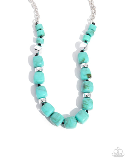 Turquoise beaded necklace with silver accents on a white background