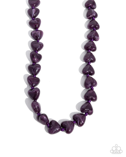 Necklace with purple heart-shaped beads on a white background