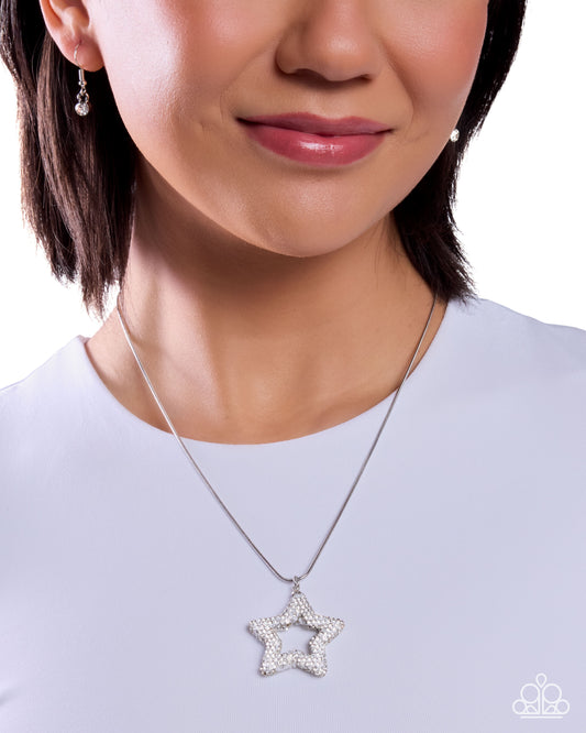 Star-shaped necklace worn by a person on a white background