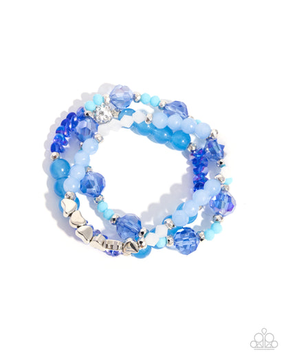 Blue beaded bracelet with silver heart charms on a white background