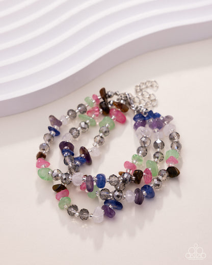 Colorful beaded bracelets on a white surface