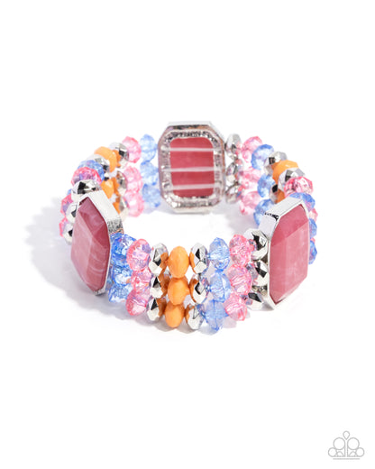 Multicolored beaded bracelet with pink and orange accents on a white background