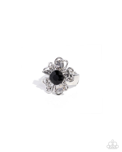 Silver ring with a black gemstone on a white background