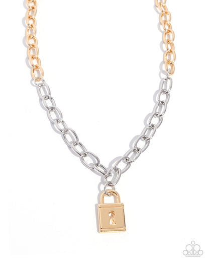 A two-tone chain necklace featuring a silver-toned paperclip link style and a gold-toned curb link style, with a small gold padlock pendant hanging from the center. The necklace is displayed on a clean white background.