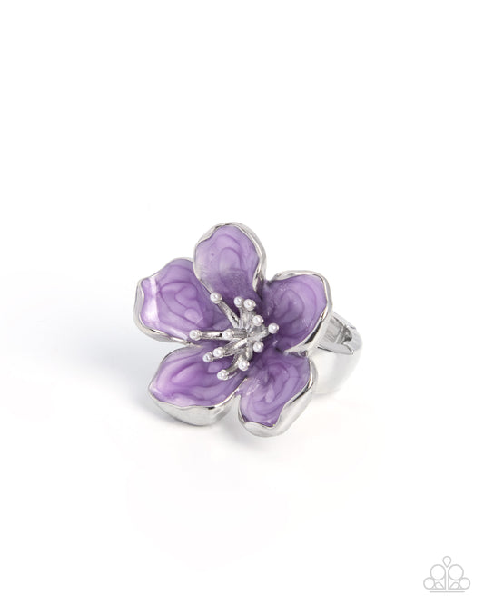 Purple flower-shaped ring with silver accents on a white background