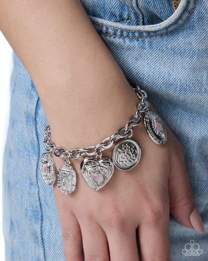 Feminine Focus cat's-eye stone and silver charm bracelet detail