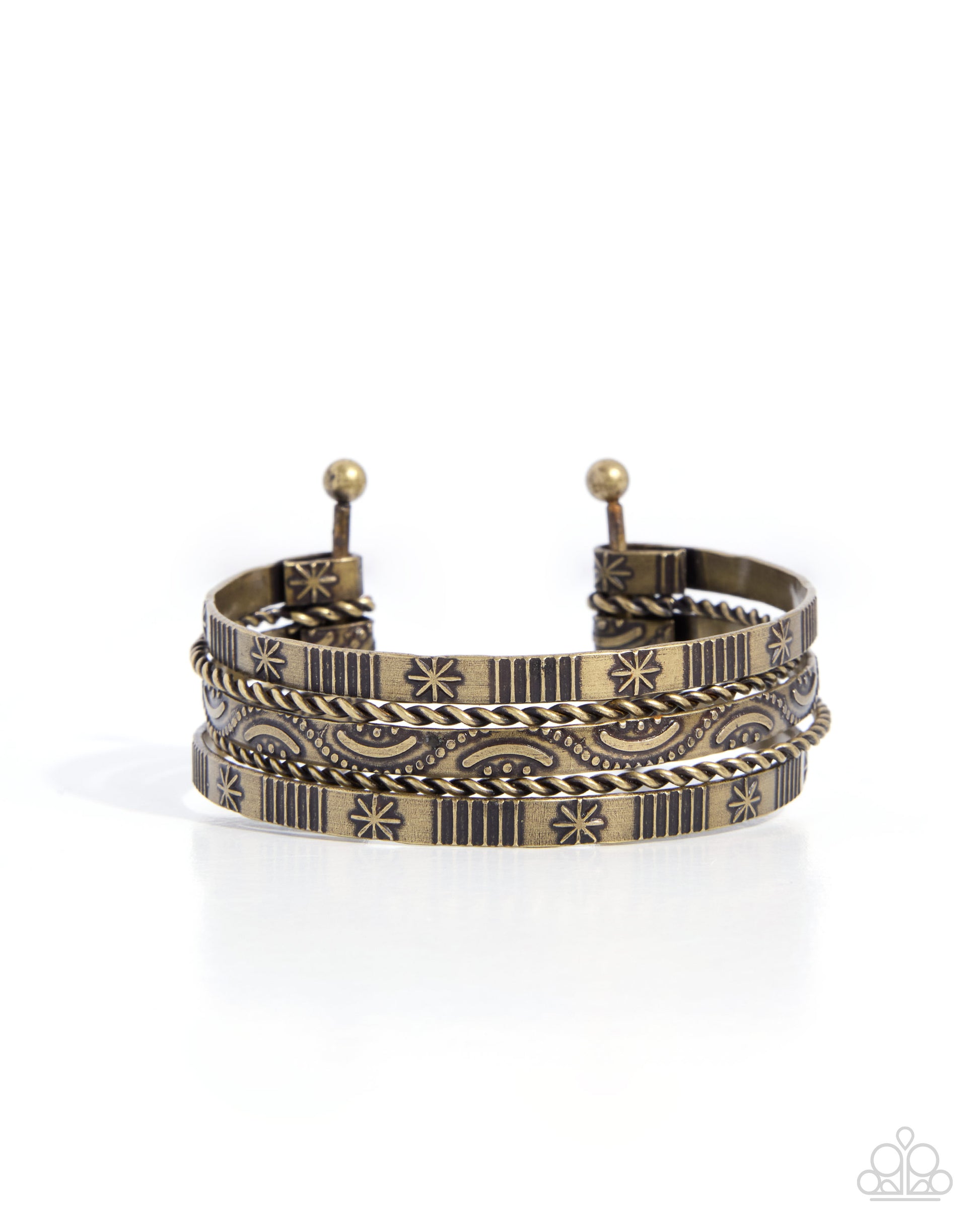 A multi-layered cuff bracelet featuring a mix of textured rope, striped, and floral engraved patterns in antique gold and dark oxidized tones, displayed on a clean white background.