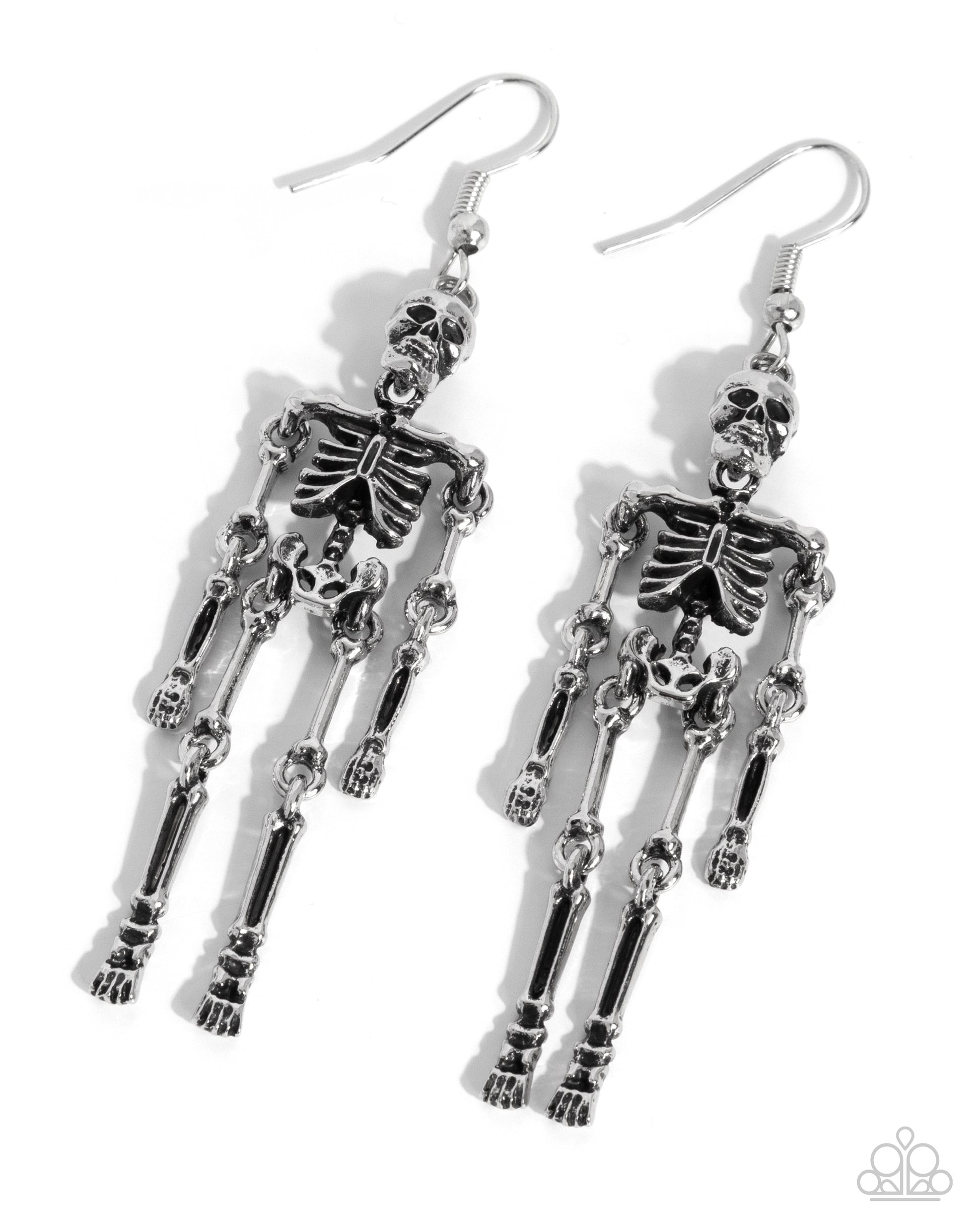 A pair of dangling skeleton earrings in polished silver-tone metal, shown on a clean white background with soft drop shadows. The earrings feature detailed articulated skeleton figures hanging from fishhook wires.