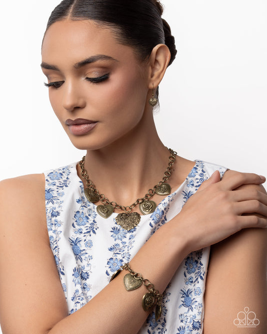 Woman wearing a gold necklace and bracelet on a white background