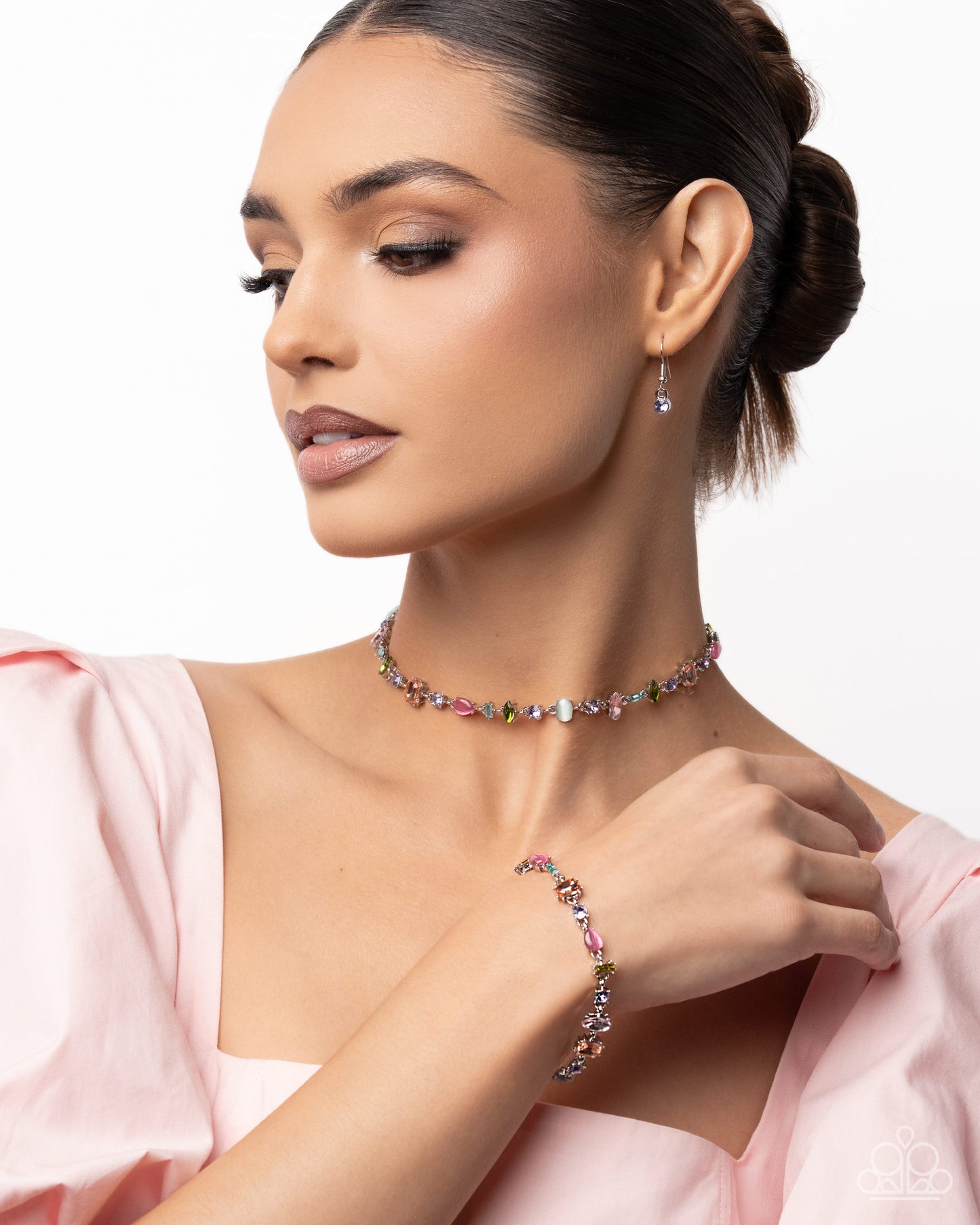 Woman wearing a colorful beaded necklace and bracelet on a white background