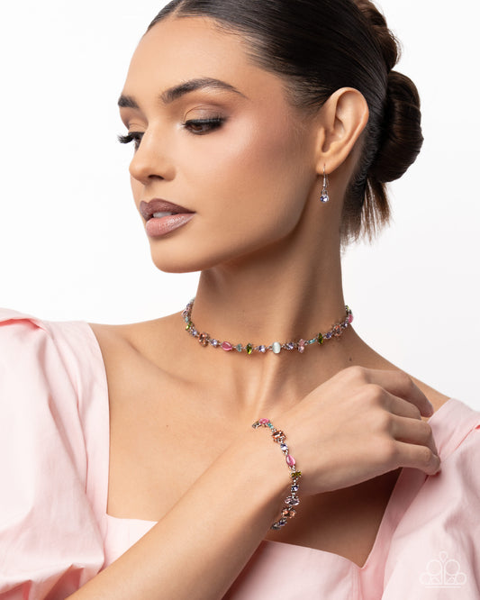 Woman wearing a colorful beaded necklace and bracelet on a white background