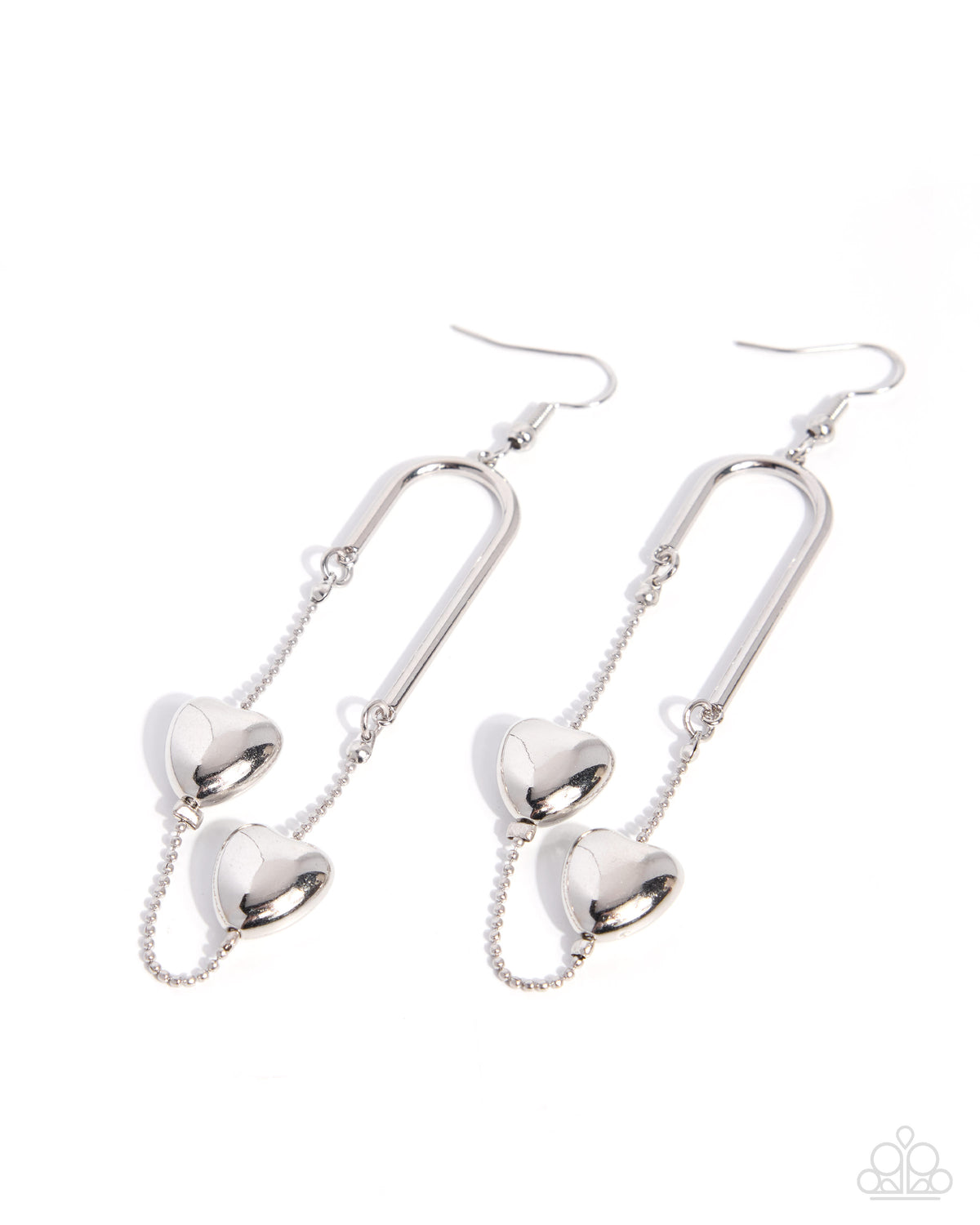 A pair of silver drop earrings featuring three-dimensional heart charms suspended from curved bar hooks, shown against a plain white background.