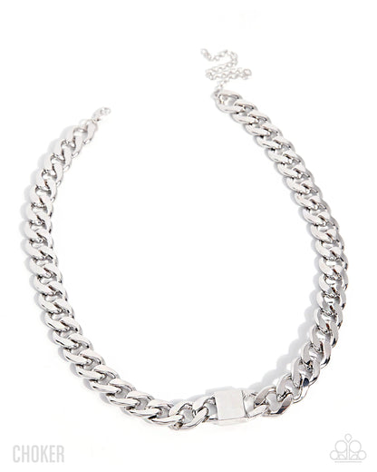 A silver-toned chunky curb chain necklace with a square clasp, displayed on a clean white background. The brand name 'CHOKER' is printed in the bottom-left corner, and the Adidas logo is visible in the bottom-right corner.