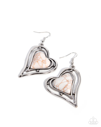 A pair of heart-shaped dangle earrings featuring a polished silver-tone double-heart frame with a central white and beige marbled stone, shown on a plain white background.