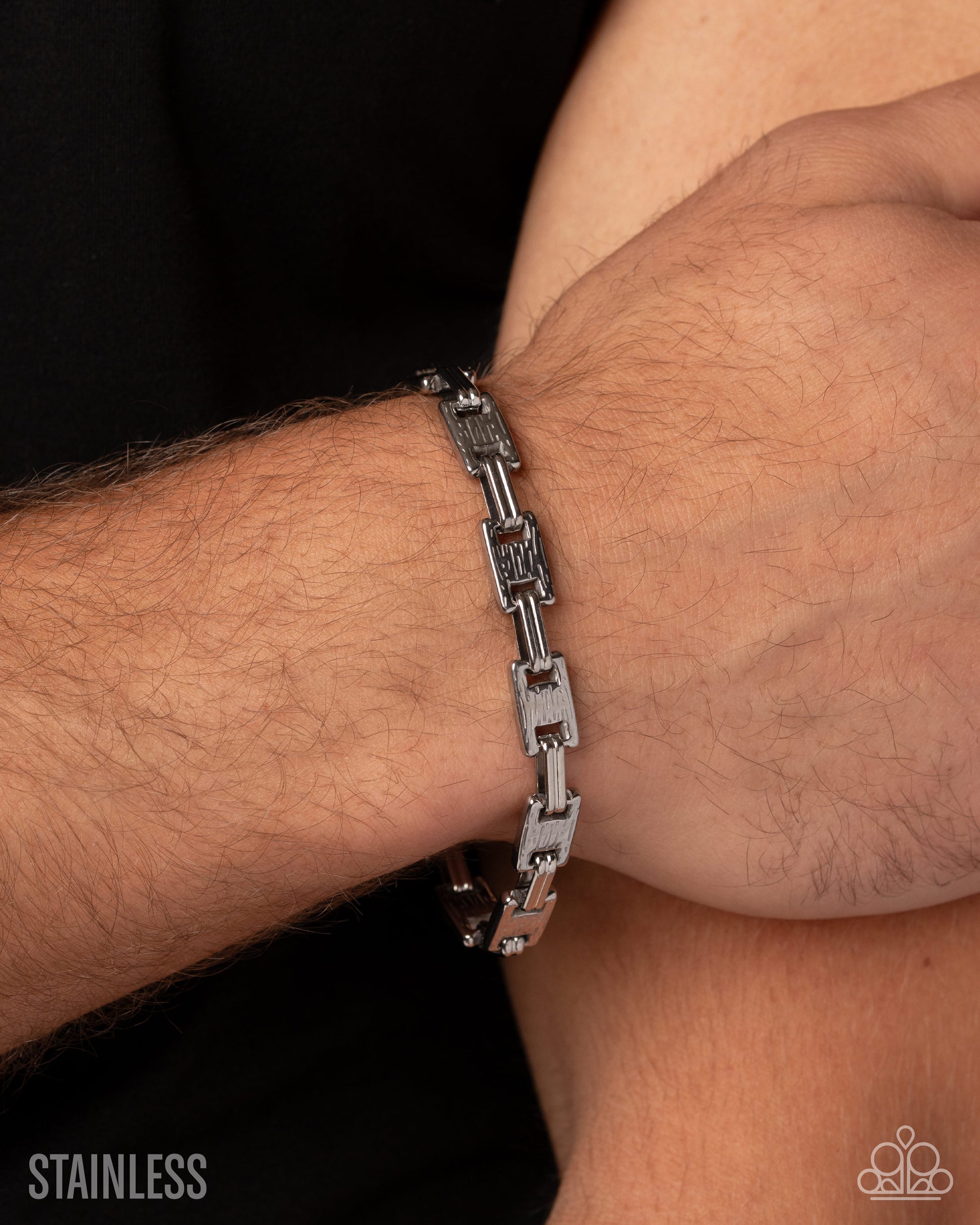A close-up of a silver stainless steel link bracelet worn on a person's wrist, with the brand logo 'KODAK' visible in the bottom right corner and 'STAINLESS' text in the bottom left.