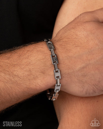 A close-up of a silver stainless steel link bracelet worn on a person's wrist, with the brand logo 'KODAK' visible in the bottom right corner and 'STAINLESS' text in the bottom left.