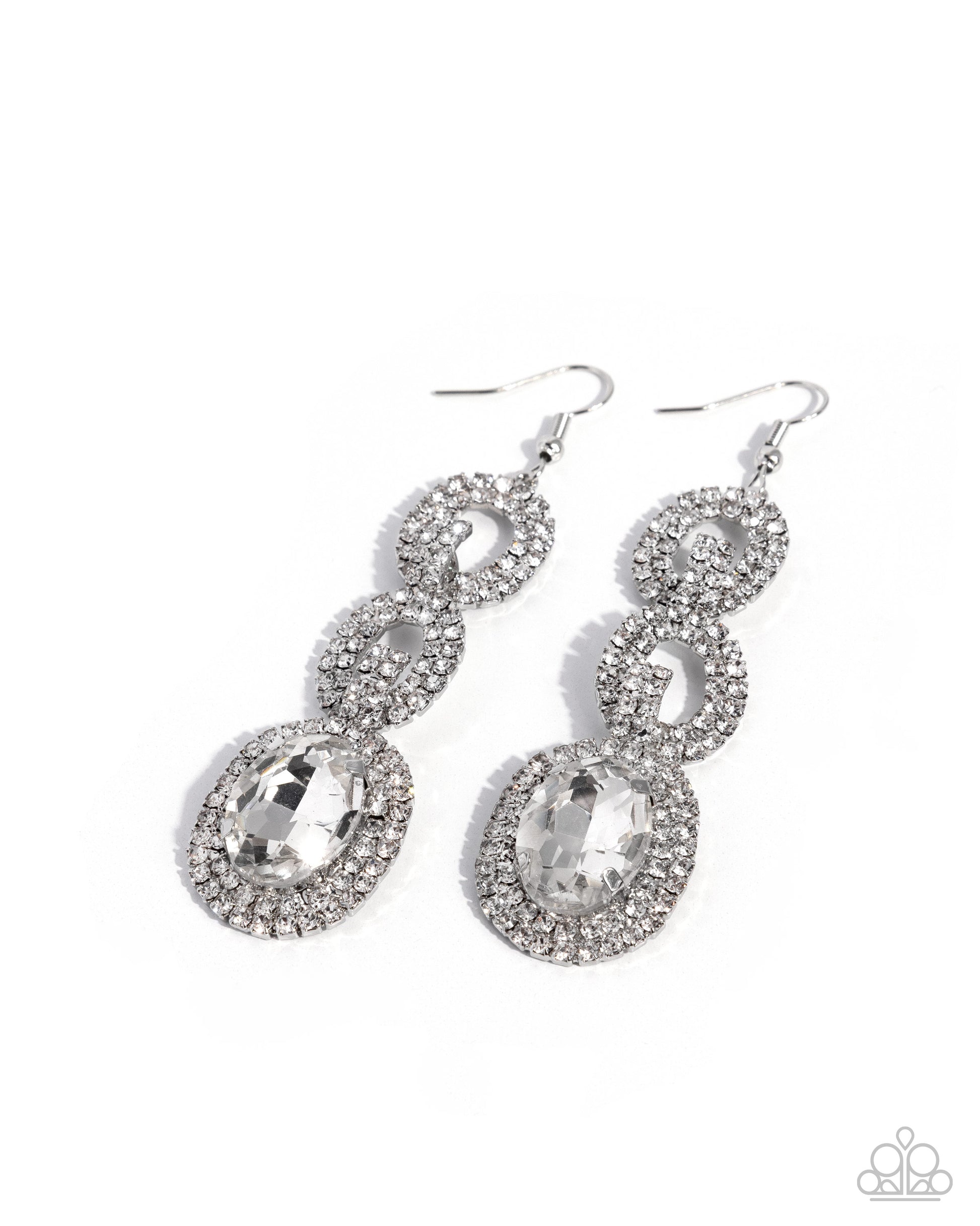 A pair of silver-toned dangle earrings adorned with clear rhinestones and large oval clear gemstones, shown on a plain white background.