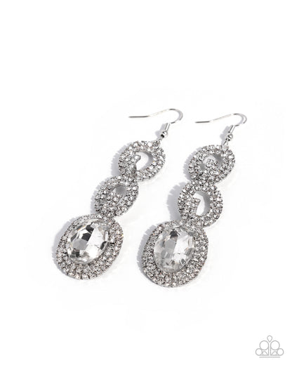 A pair of silver-toned dangle earrings adorned with clear rhinestones and large oval clear gemstones, shown on a plain white background.