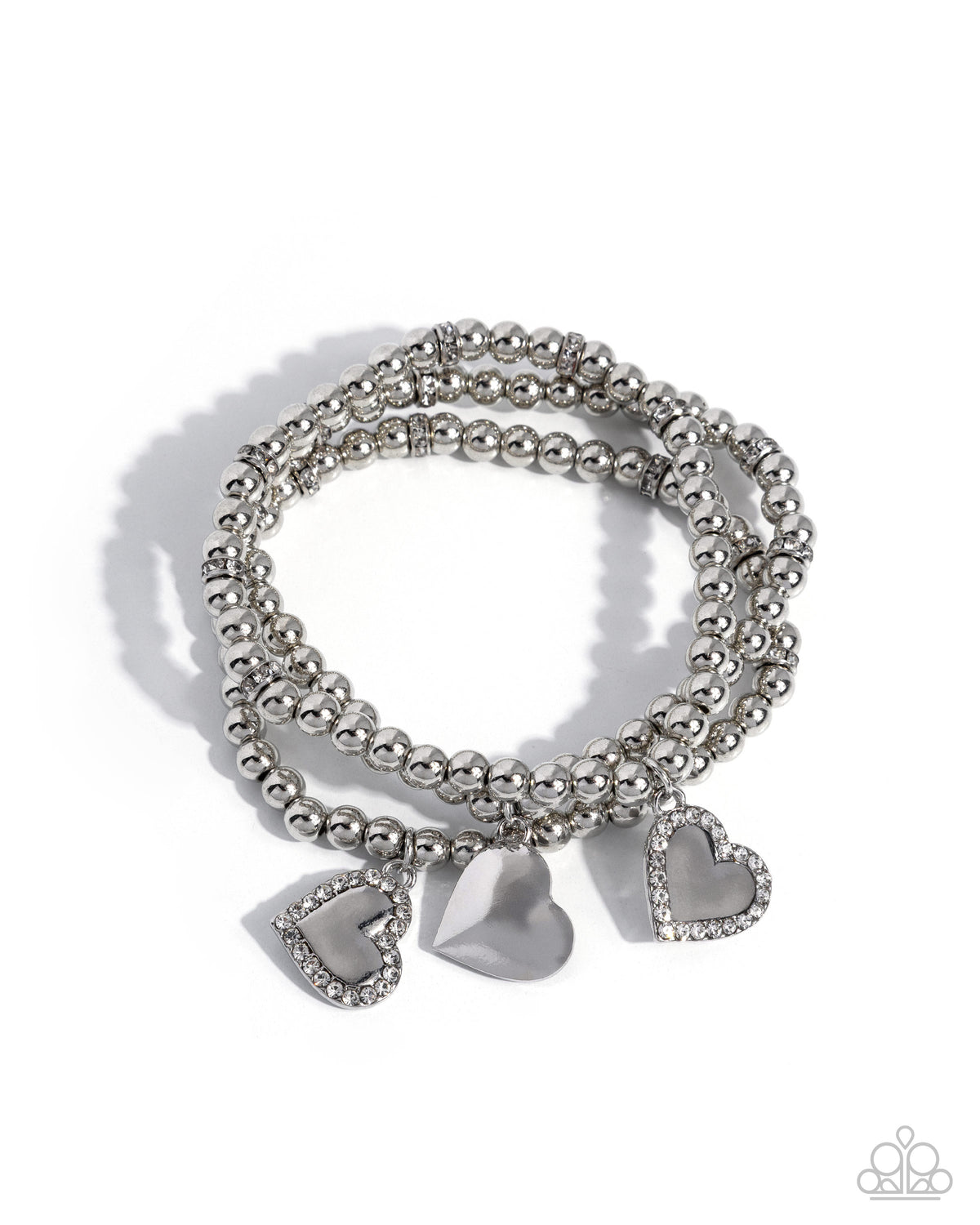 A set of three silver beaded stretch bracelets with heart-shaped charms, including one smooth silver heart and two heart charms encrusted with small clear rhinestones, on a white background.