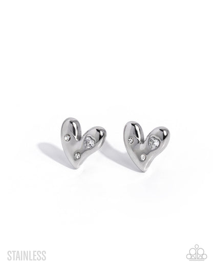 A pair of polished stainless steel heart-shaped stud earrings with small clear crystal accents, shown on a clean white background with soft shadows.
