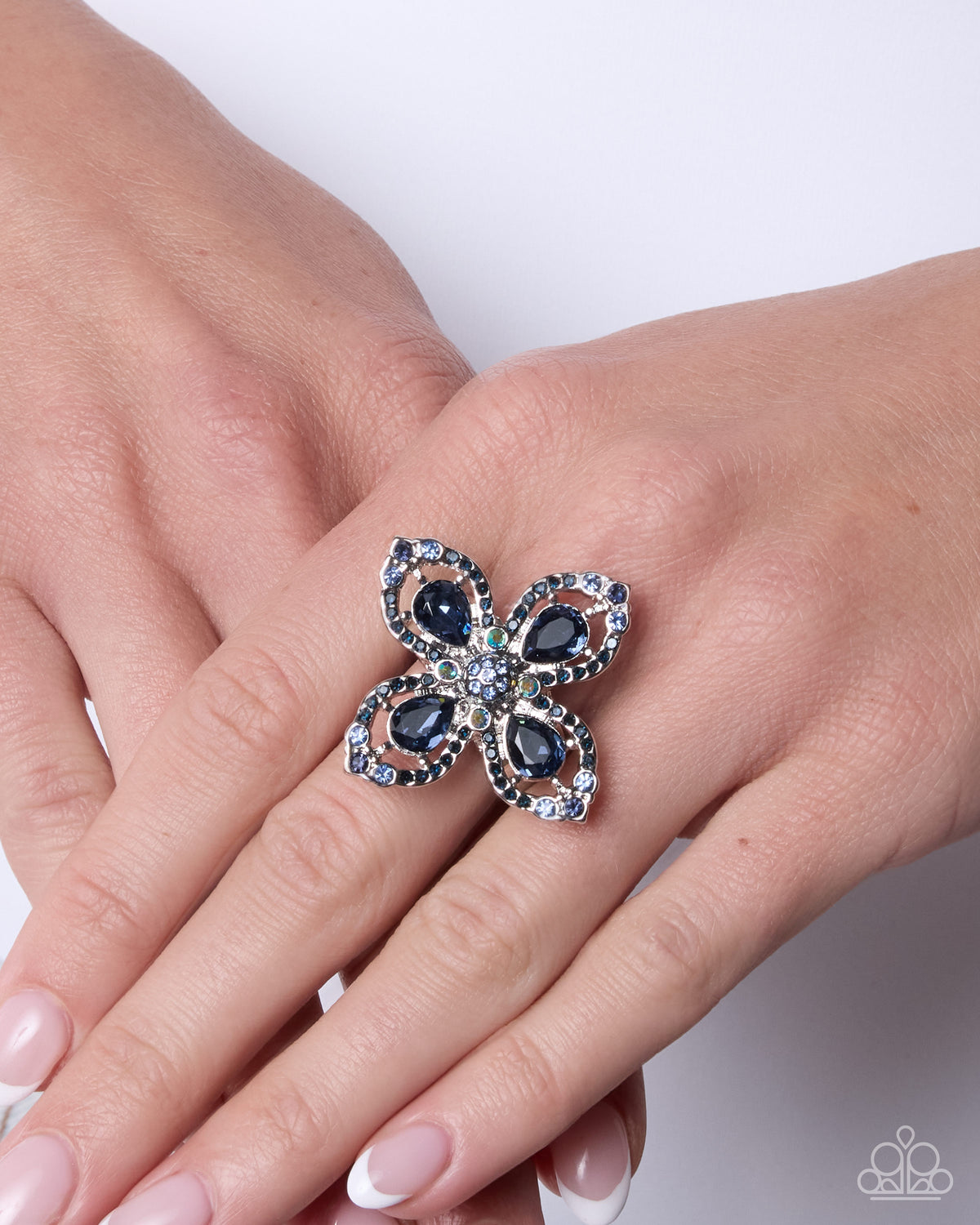Whimsical Honor blue stretch ring styled on hand