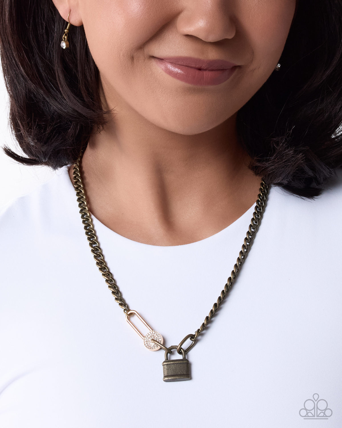 Close-up of brass and gold-tone lock pendants with rhinestones