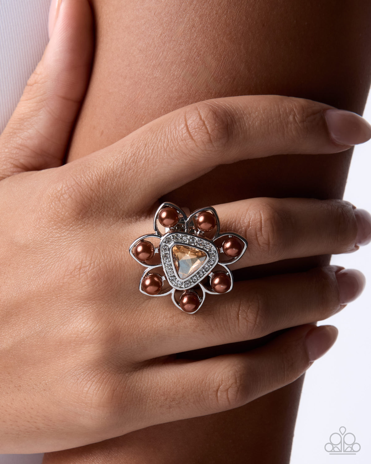 Close-up of champagne gem and chocolate pearl floral ring