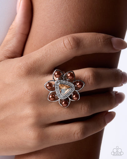 Close-up of champagne gem and chocolate pearl floral ring