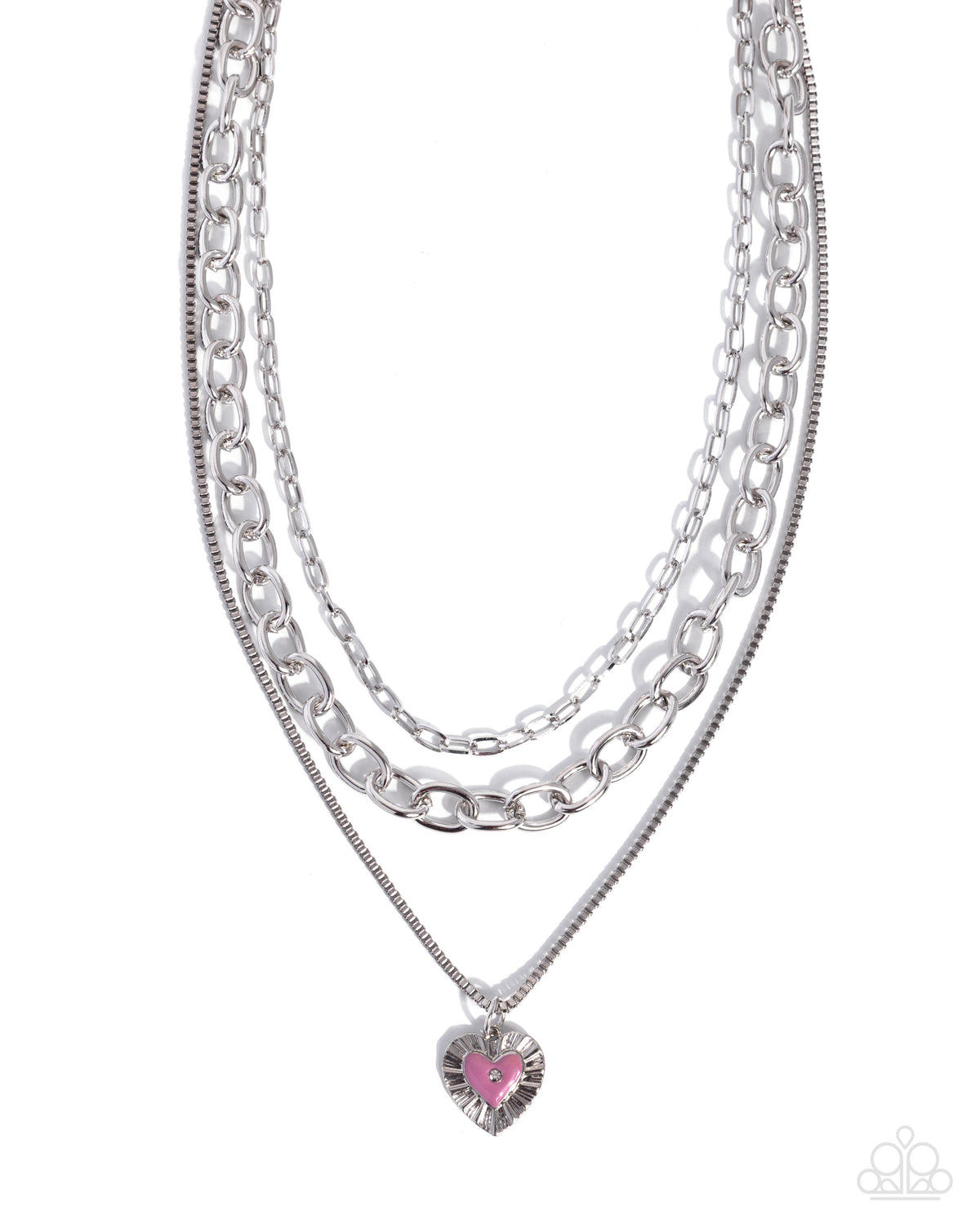 A layered silver-tone necklace featuring three distinct chain styles and a dangling heart-shaped charm with a pink center, shown against a plain white background.