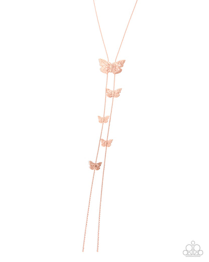 A rose gold lariat necklace featuring a main chain with four smaller dangling butterfly charms, displayed on a clean white background.
