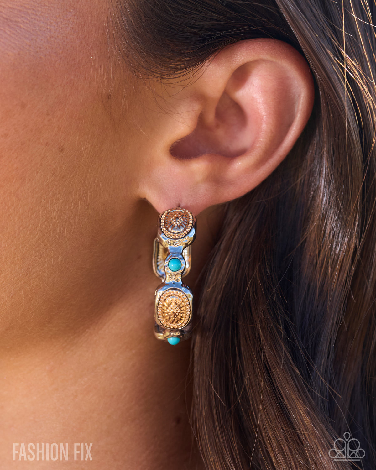 A close-up of a model's ear wearing a gold-toned multi-link earring with turquoise blue stones and ornate detailing. The image features the 'FASHION FIX' logo in the bottom-left corner and the 'O'Kawa' logo in the bottom-right corner.