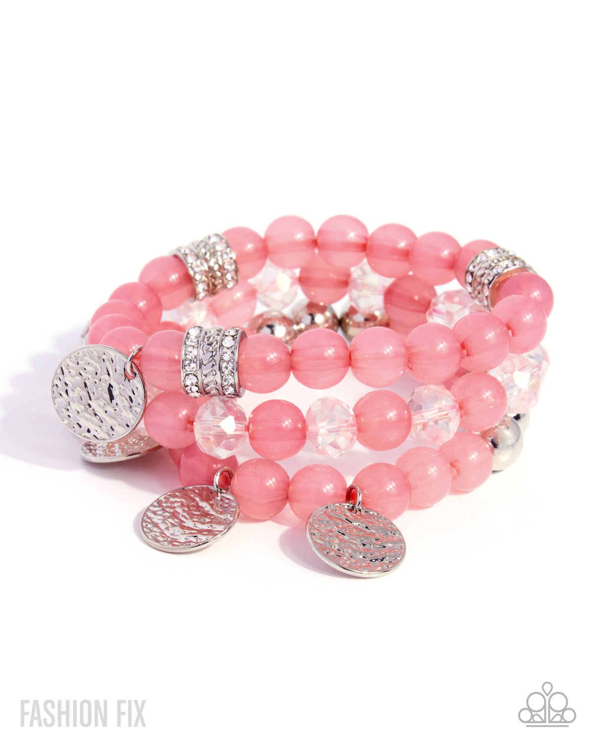 A stack of pink beaded stretch bracelets with silver-tone textured disc charms and rhinestone-embellished spacer rings, displayed on a clean white background.