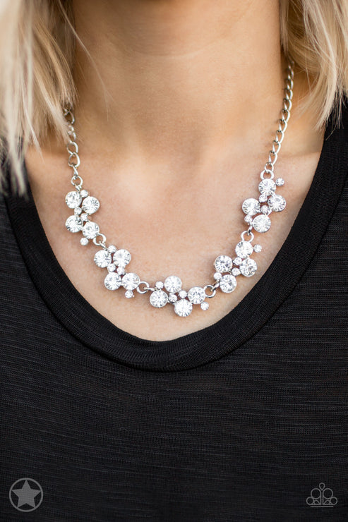 Silver floral necklace on a person wearing a black top