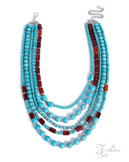 A multi-strand statement necklace featuring turquoise beads, dark red cylindrical beads, and silver spacer rings, displayed on a clean white background with a brand watermark in the lower right.