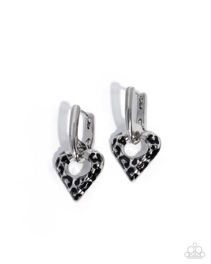 Heart-shaped earrings with black leopard print design on a white background
