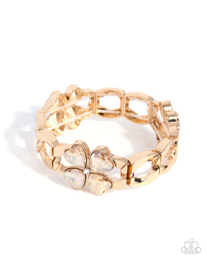 Gold bracelet with floral design on a white background