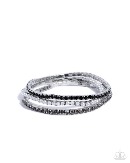 Close-up of Colorful Cabaret black rhinestone and white pearl bracelet trio