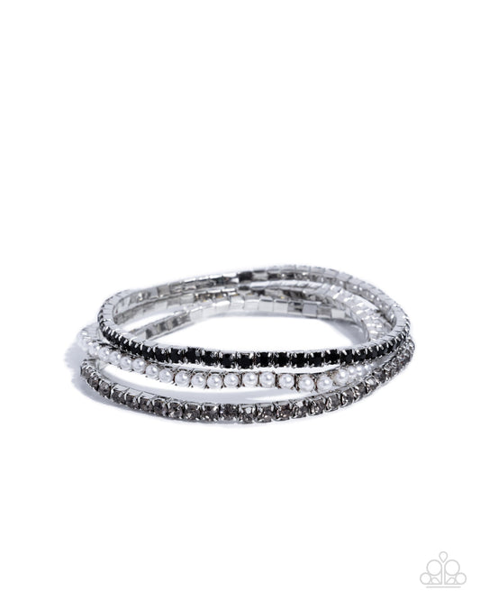 Close-up of Colorful Cabaret black rhinestone and white pearl bracelet trio