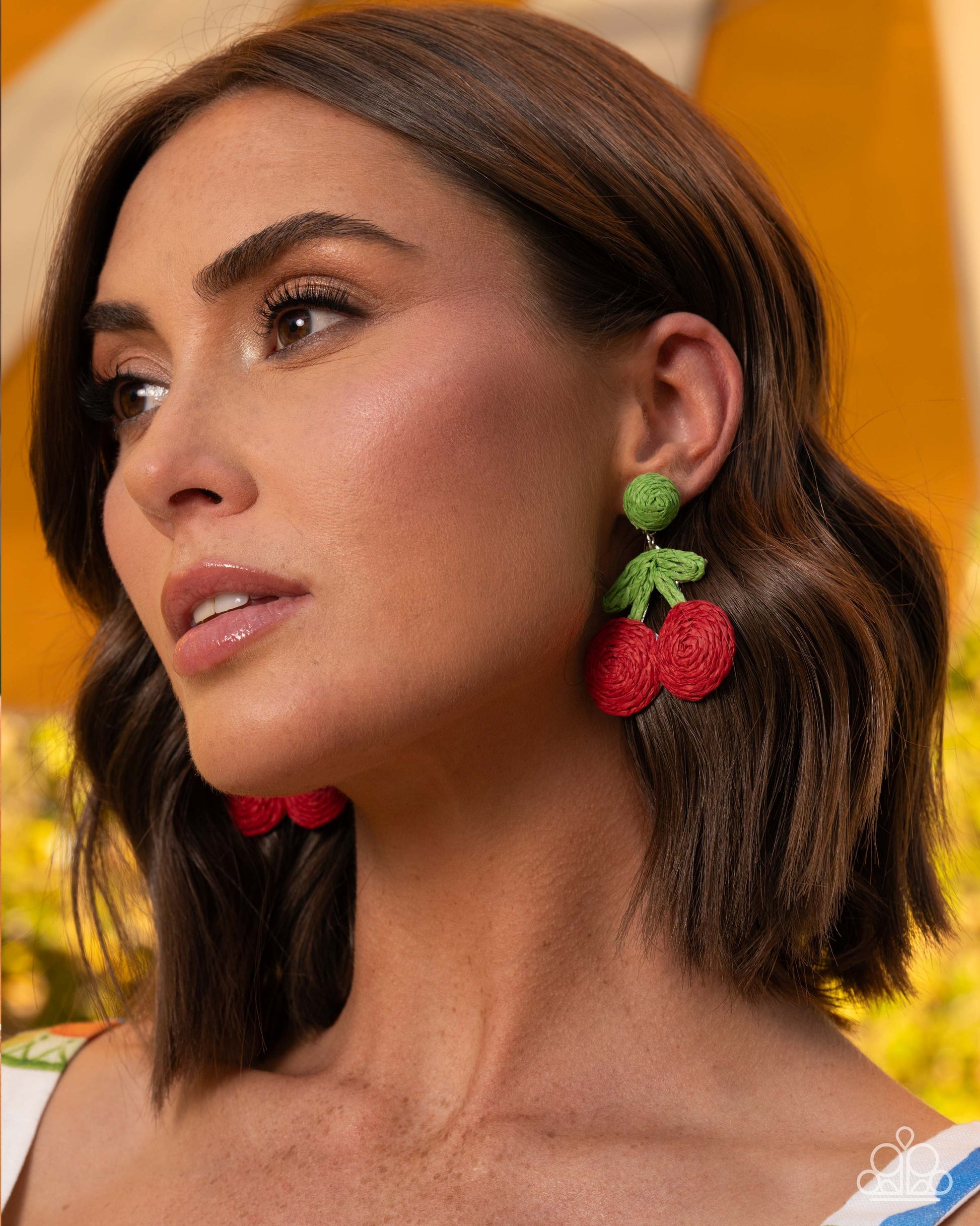 Crafted Cherry red raffia earrings displayed on jewelry card