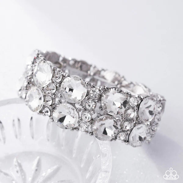 Silver bracelet with clear gemstones on a white background