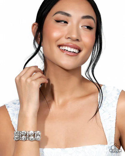 Woman wearing a silver bracelet on a white background