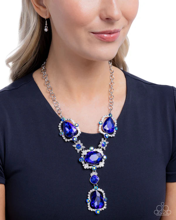 Woman wearing a blue teardrop necklace on a white background