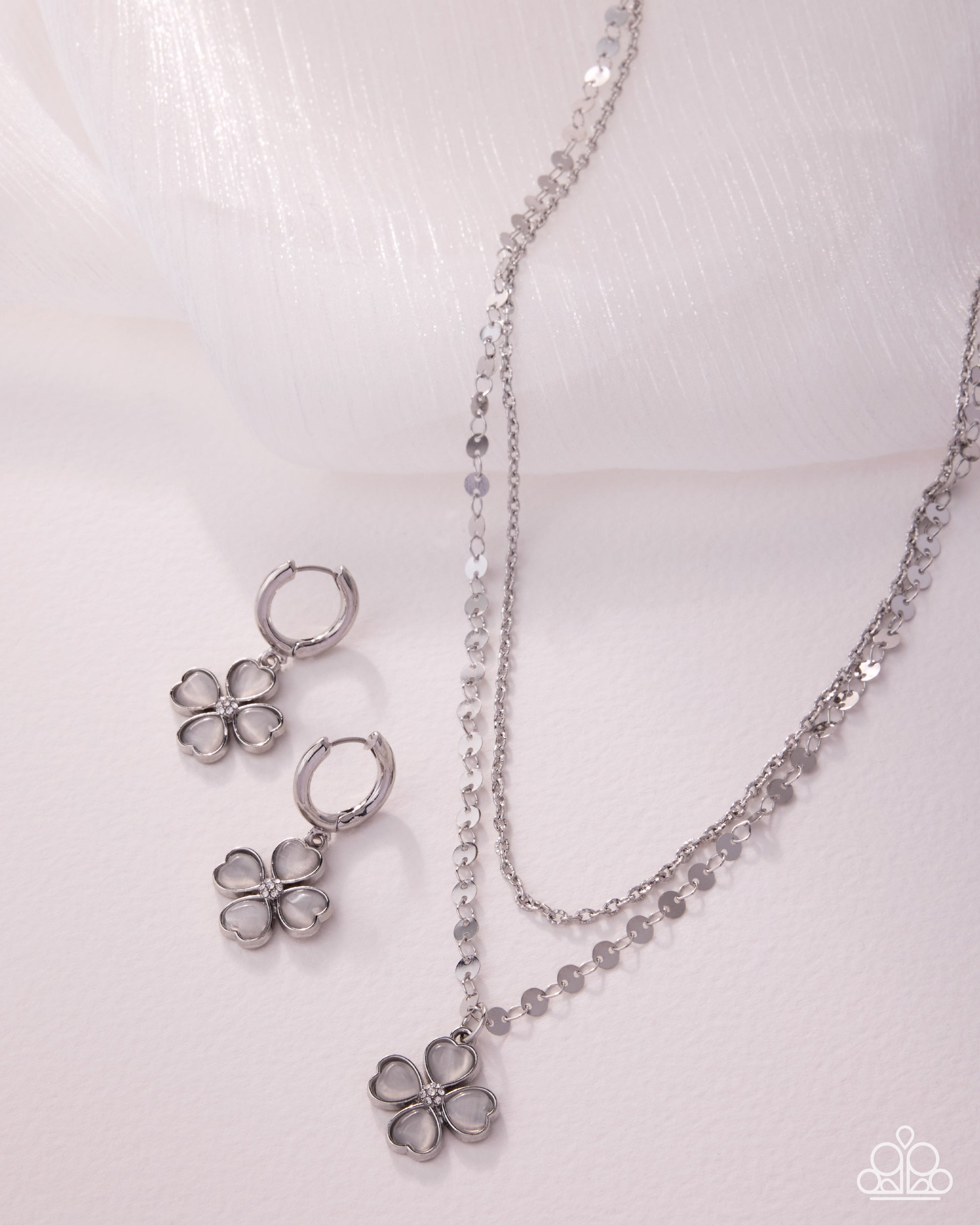 Silver flower jewelry set on a white background