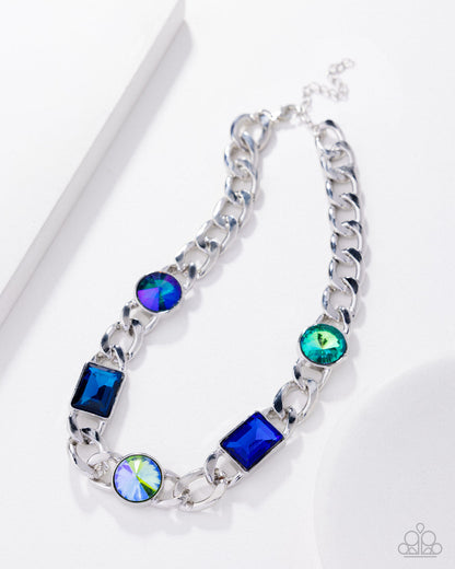 Silver chain bracelet with blue and green gemstones on a white background
