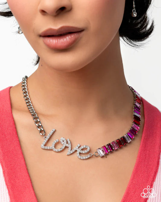 Necklace with 'LOVE' lettering and gemstones worn by a model